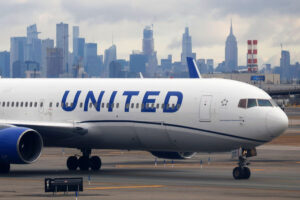 United Airlines aircraft at Newark Liberty International Airport with New York City skyline