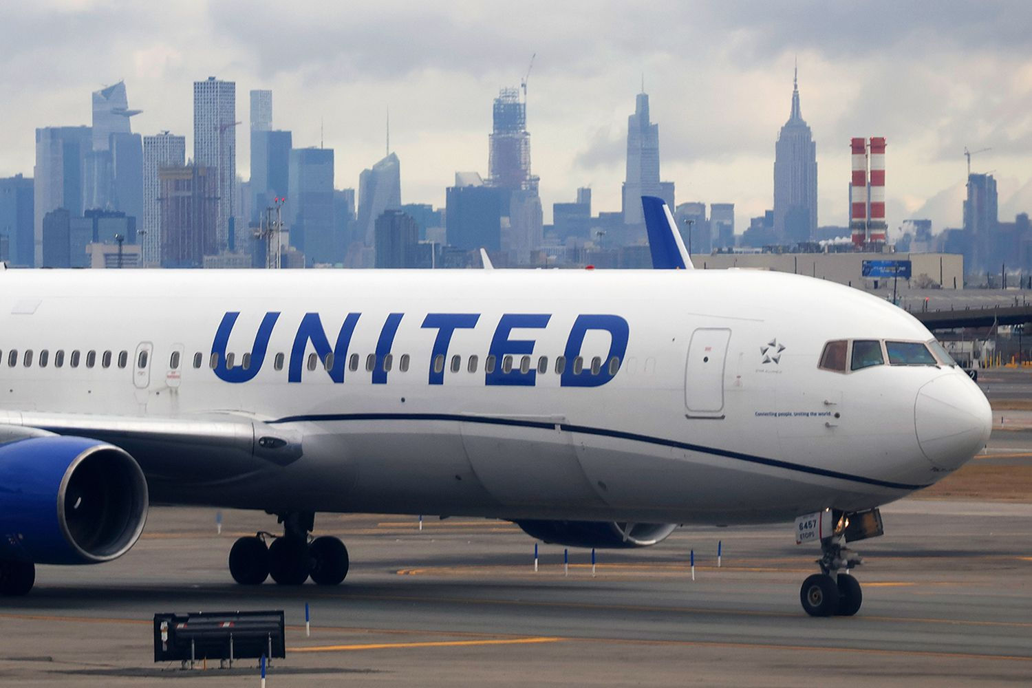 United Airlines aircraft at Newark Liberty International Airport with New York City skyline
