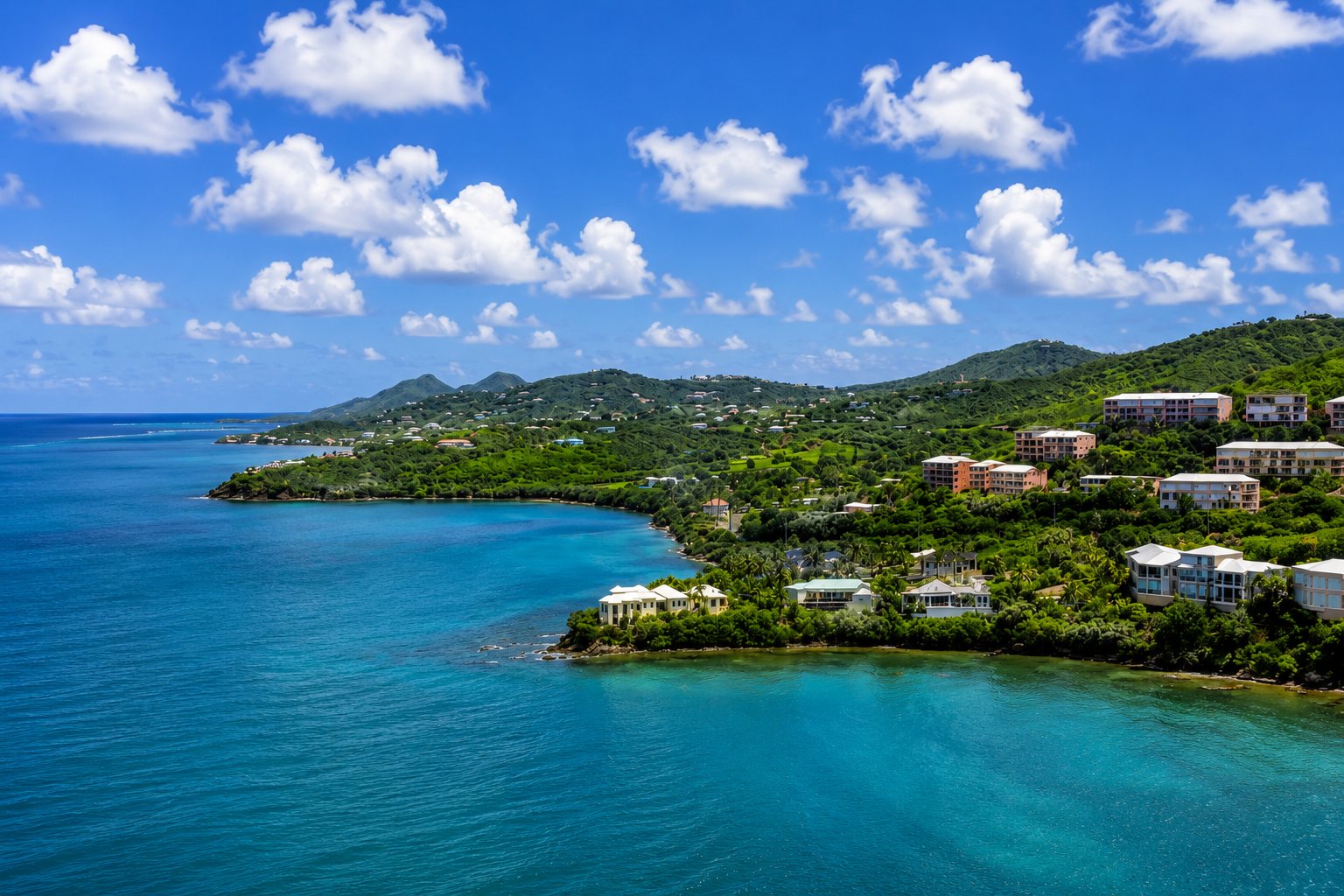 Aerial drone view of Carden Beach and Coakley Bay condominiums on St. Croix’s East End, featuring turquoise Caribbean waters, lush green hillsides, and waterfront condo communities.