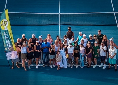 Players gathered at the net for a group photo at the Just Beat It St. Croix tennis tournament