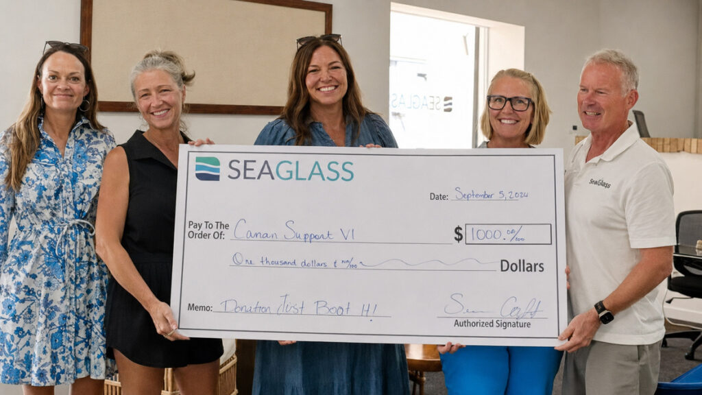 Sea Glass Properties presents a donation check to Cancer Support VI
