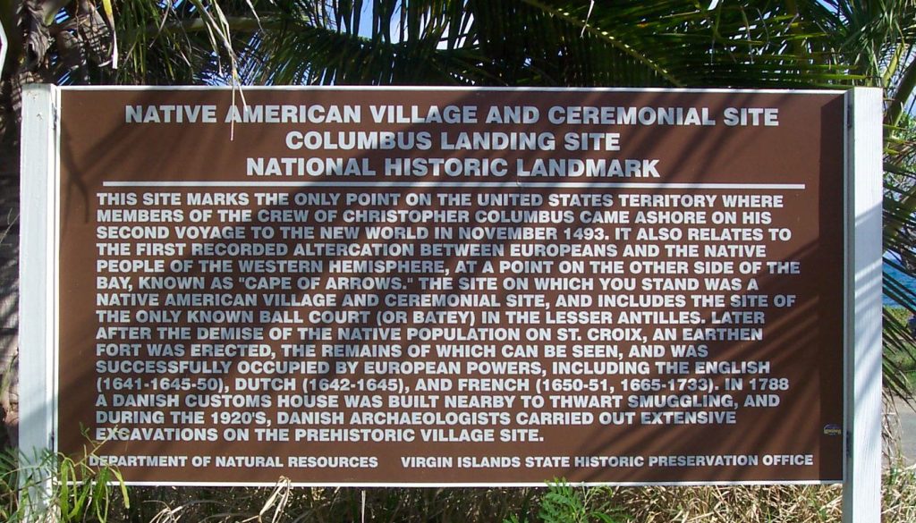 Brown historical marker reading Native American Village and Ceremonial Site, Columbus Landing Site, National Historic Landmark, describing the 1493 landing and the Cape of Arrows at Salt River Bay, St. Croix.